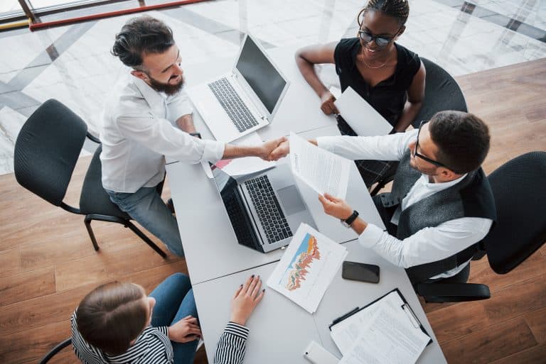 grupo de gestores em reunião em uma mesa com vista de cima